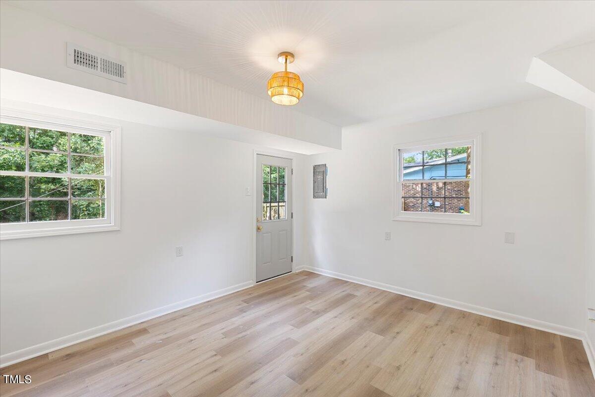 134 Radcliff Circle Durham, NC 27713 - Photo 32 of 37 a view of empty room with window and wooden floor