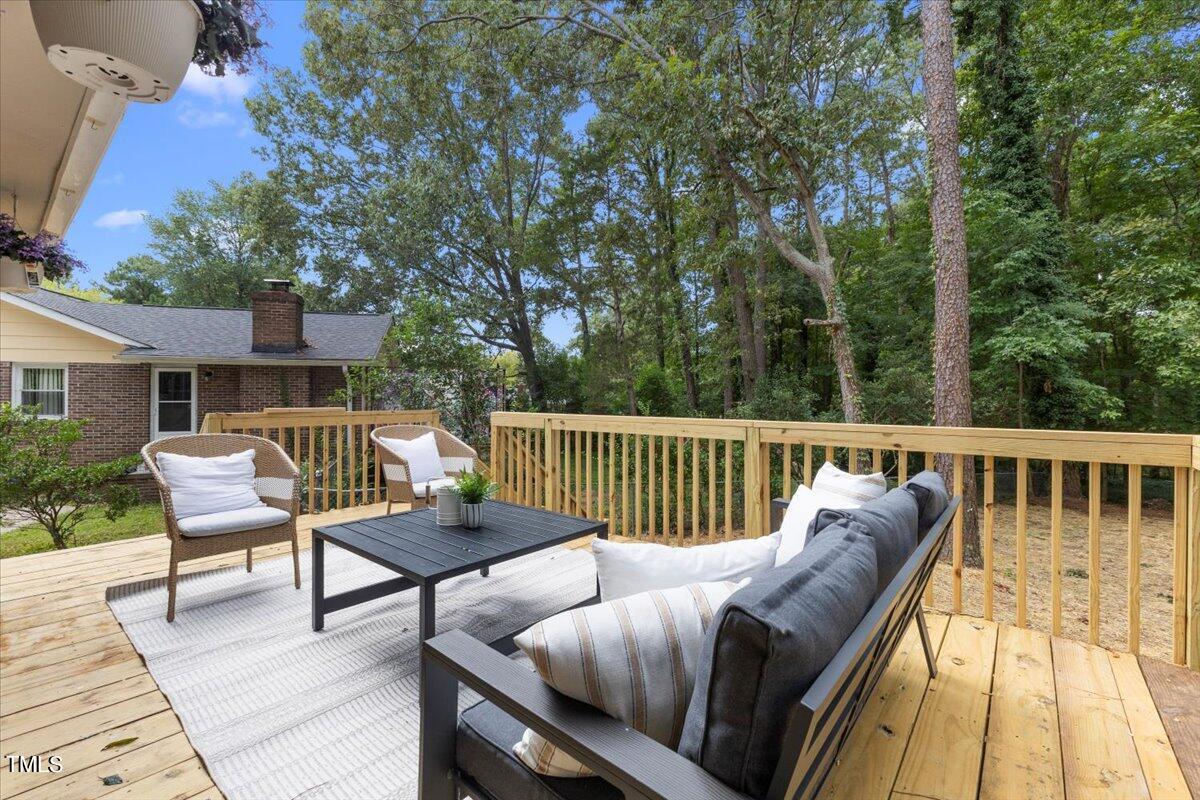 134 Radcliff Circle Durham, NC 27713 - Photo 33 of 37 a balcony with wooden floor and outdoor seating