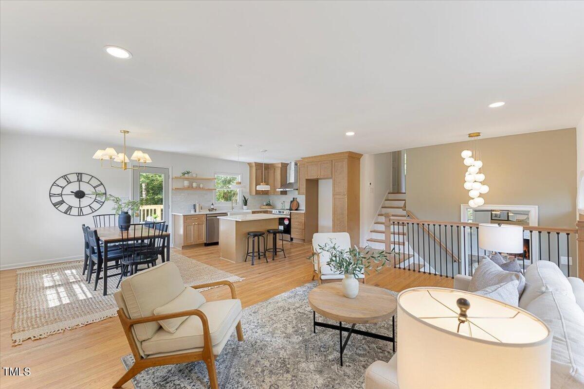 134 Radcliff Circle Durham, NC 27713 - Photo 7 of 37 a living room with furniture and a dining table with wooden floor