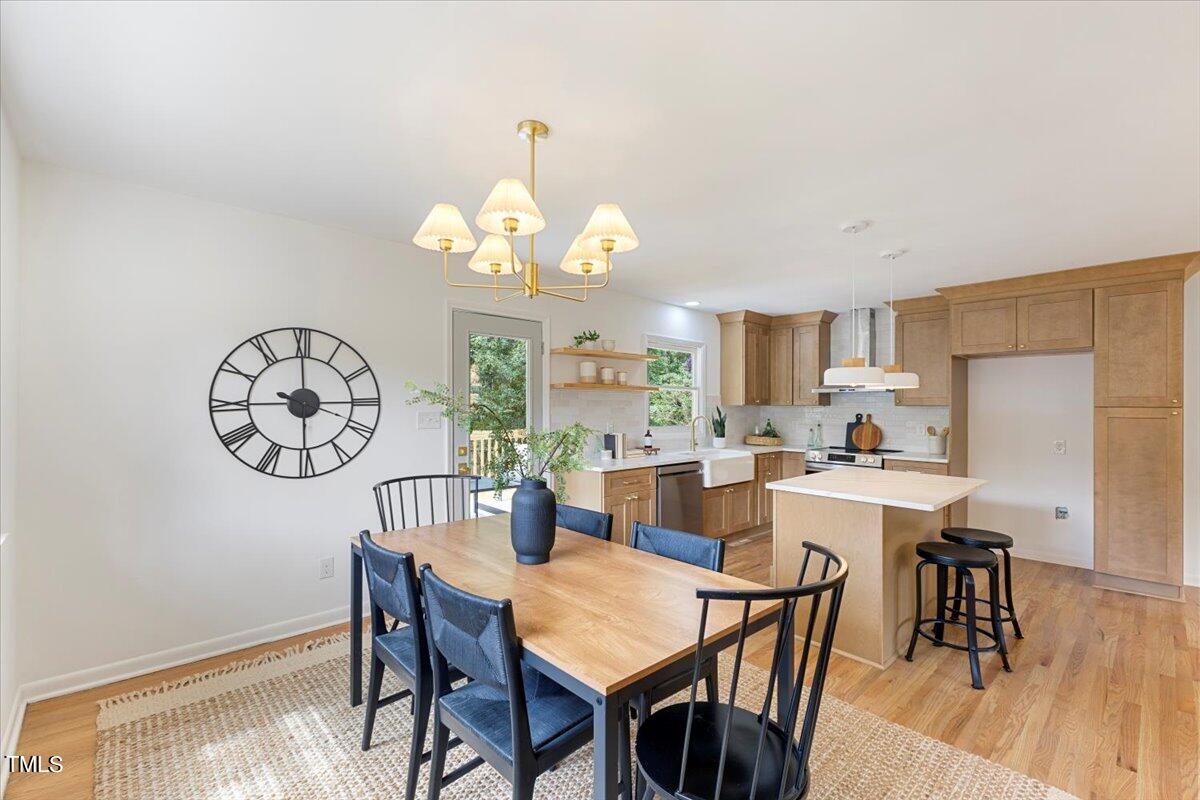 134 Radcliff Circle Durham, NC 27713 - Photo 8 of 37 a view of a dining room with furniture a chandelier and wooden floor
