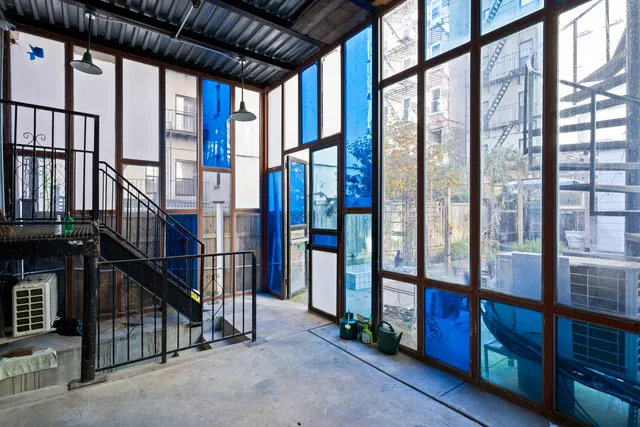 a living room with lots of furniture and a large window