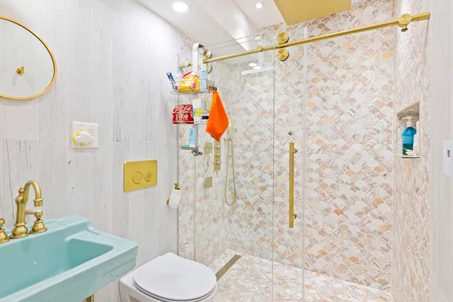 a bathroom with a sink toilet and shower