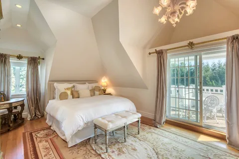 a bedroom with a bed and a large window