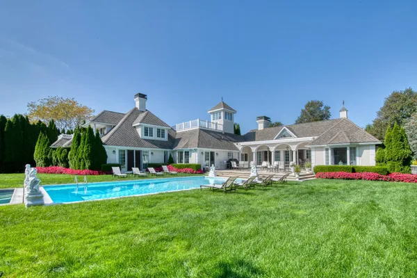 a front view of a house with a yard table and chairs