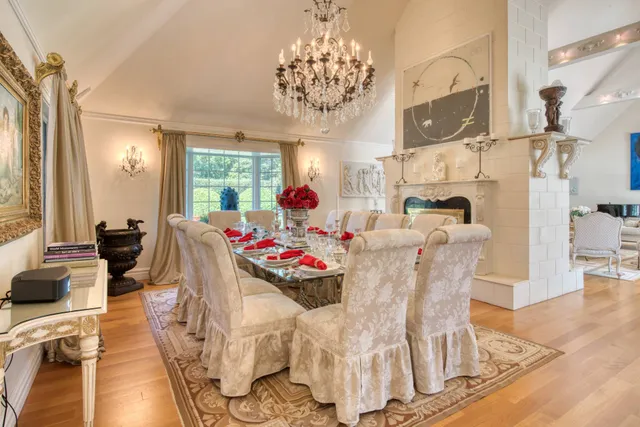 a view of a dining room with furniture a chandelier and wooden floor