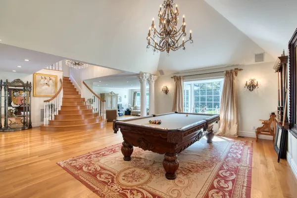 a room with pool table and windows