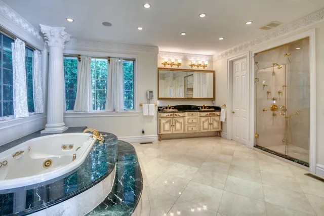 a large spacious bathroom with a large tub and shower