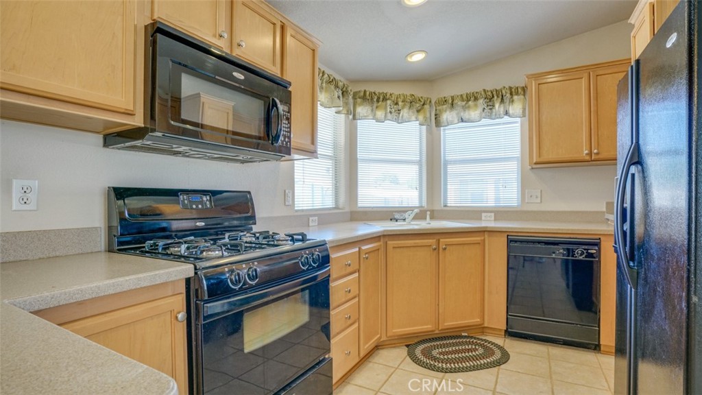 416 Jeffries, Unit 60 Monrovia, CA 91016 - Photo 16 of 49 a kitchen with stainless steel appliances granite countertop a stove a sink and a microwave