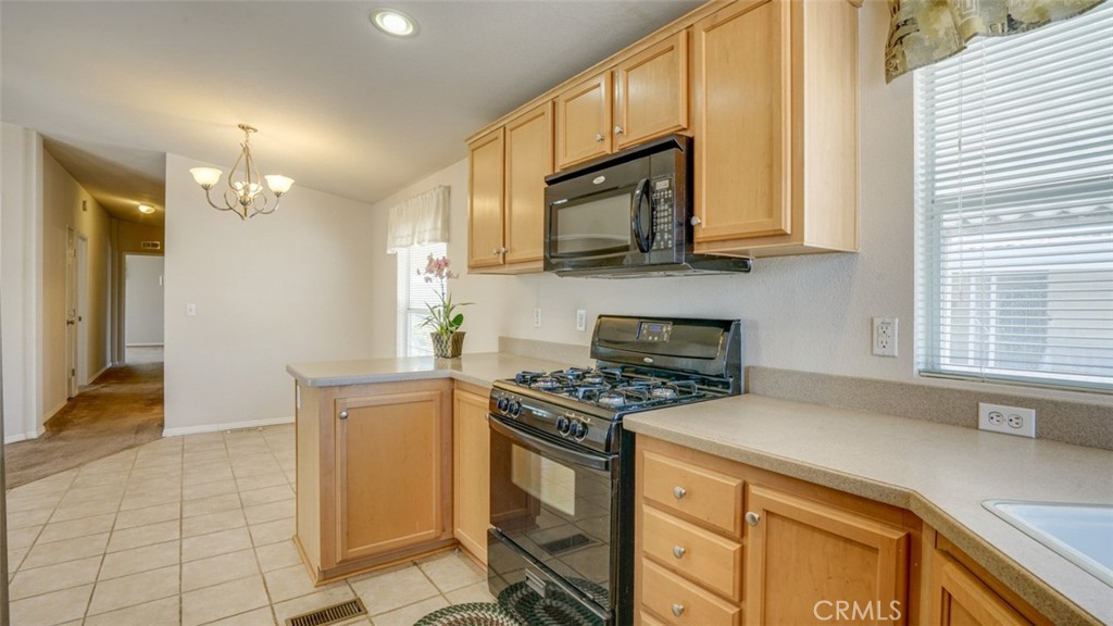 416 Jeffries, Unit 60 Monrovia, CA 91016 - Photo 17 of 49 a kitchen with stainless steel appliances granite countertop a stove a sink and a microwave