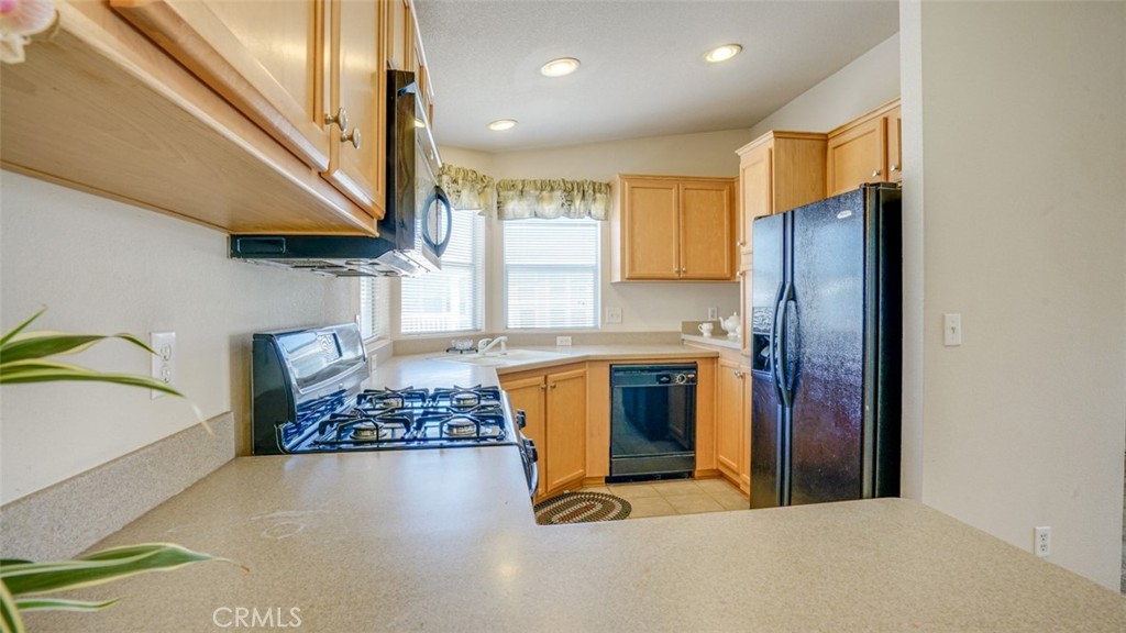 416 Jeffries, Unit 60 Monrovia, CA 91016 - Photo 19 of 49 a kitchen with stainless steel appliances granite countertop a refrigerator a stove and a sink