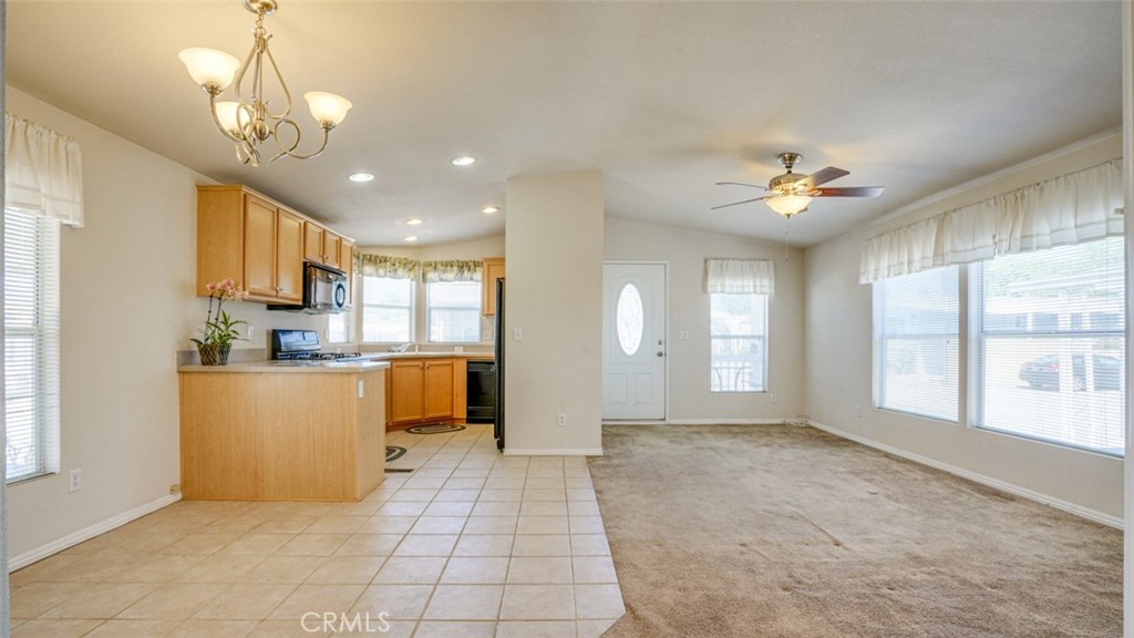 416 Jeffries, Unit 60 Monrovia, CA 91016 - Photo 10 of 49 a view of an empty room and kitchen with window ceiling fan and windows