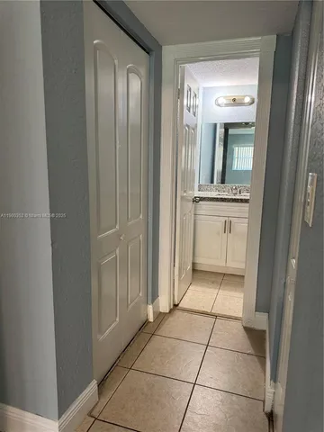 a bathroom with a granite countertop sink a mirror and a vanity