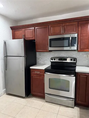 a kitchen with granite countertop cabinets and steel stainless steel appliances