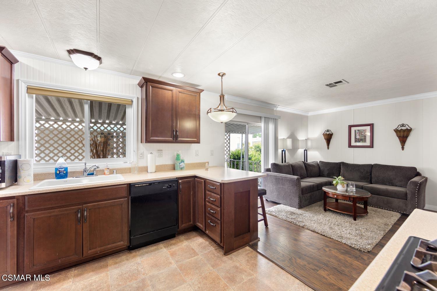195 Tierra Rejada Road, Unit 157 Simi Valley, CA 93065 - Photo 12 of 27 a living room with stainless steel appliances kitchen island granite countertop a sink dishwasher stove and cabinets