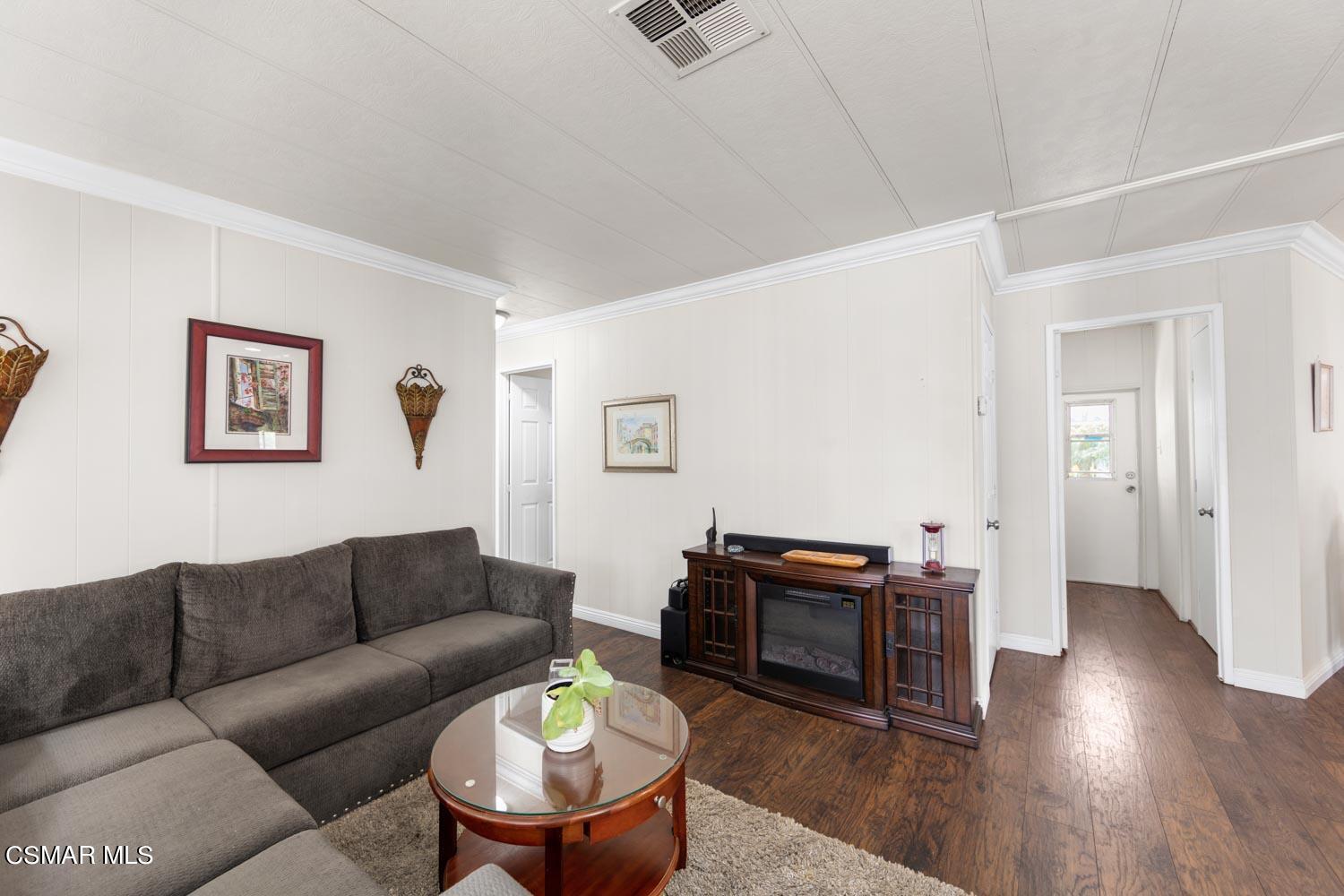 195 Tierra Rejada Road, Unit 157 Simi Valley, CA 93065 - Photo 16 of 27 a living room with furniture and wooden floor