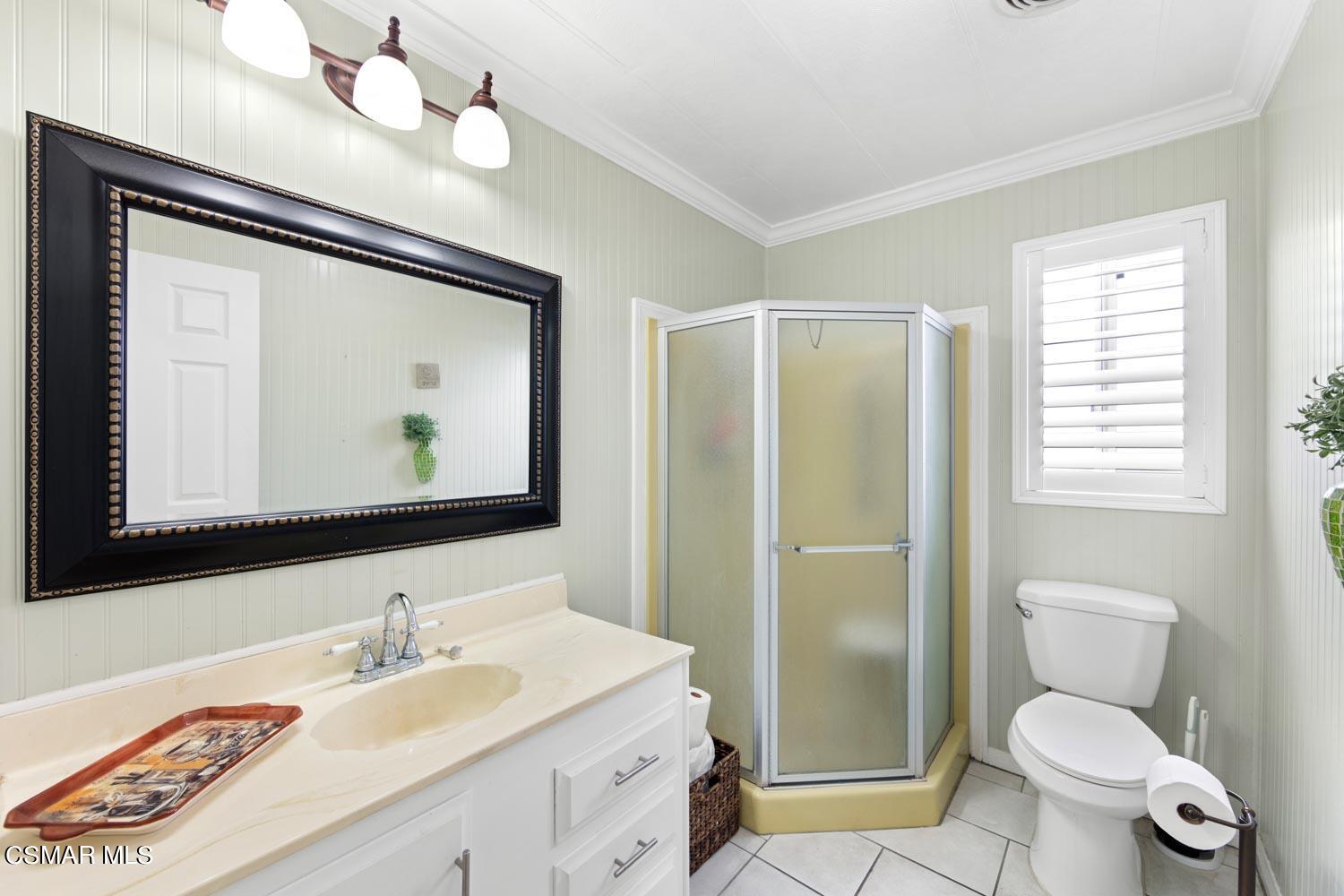 195 Tierra Rejada Road, Unit 157 Simi Valley, CA 93065 - Photo 21 of 27 a bathroom with a granite countertop toilet sink and mirror