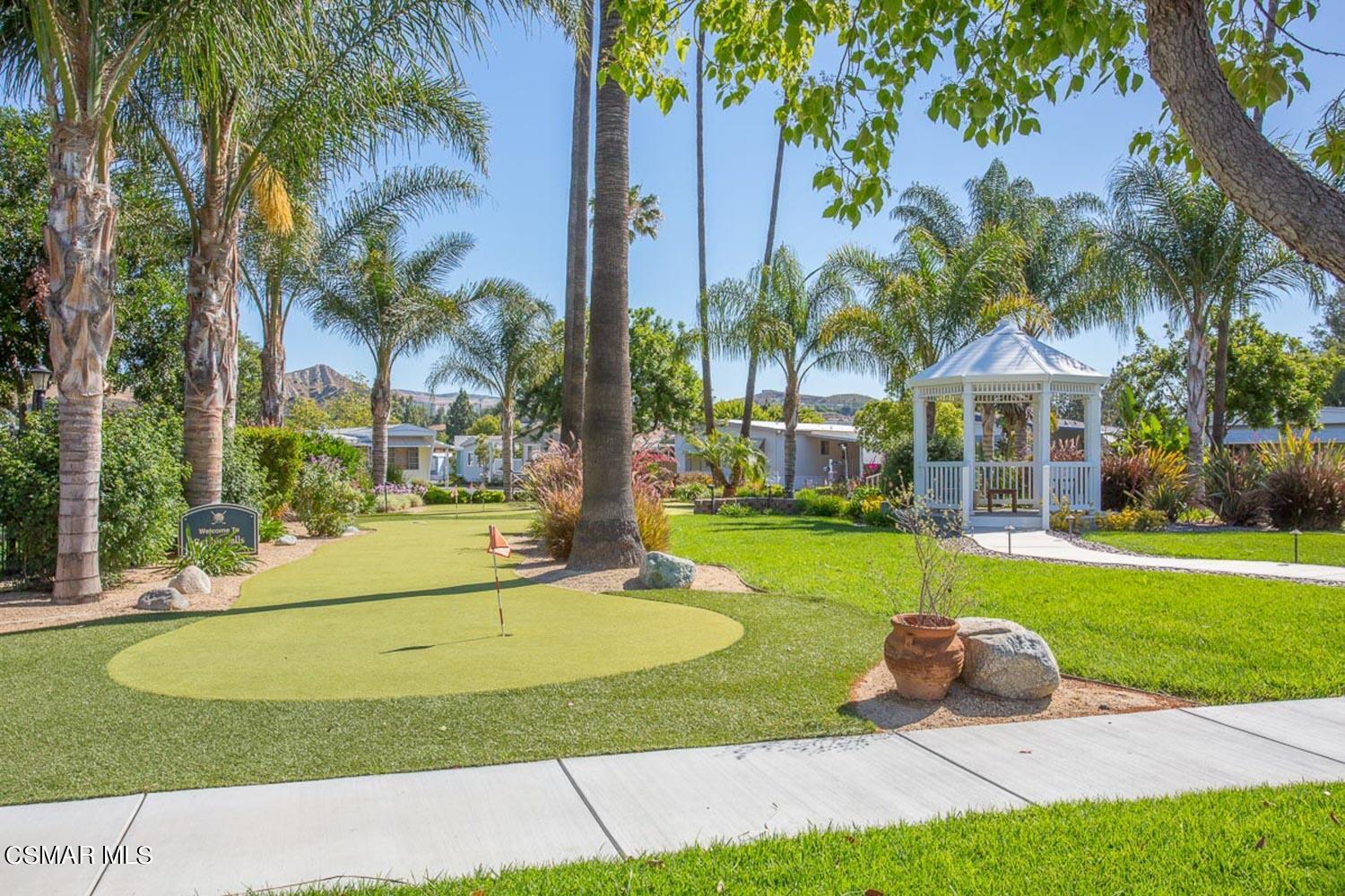 195 Tierra Rejada Road, Unit 157 Simi Valley, CA 93065 - Photo 26 of 27 a view of a house with a swimming pool and a big yard with palm trees