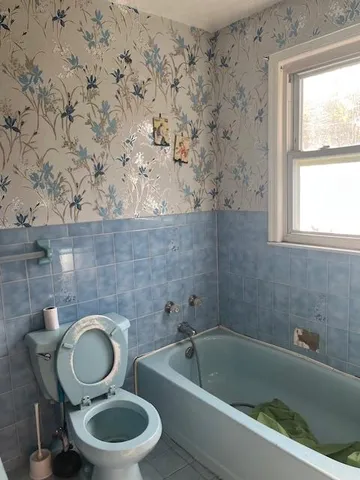 a kitchen with granite countertop a stove top oven cabinetry and a sink