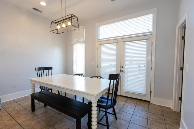 a view of a dining room with furniture and chandelier