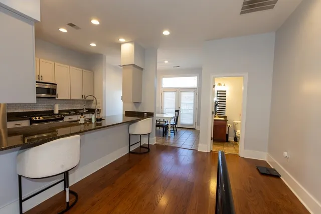 a kitchen with sink microwave and cabinets