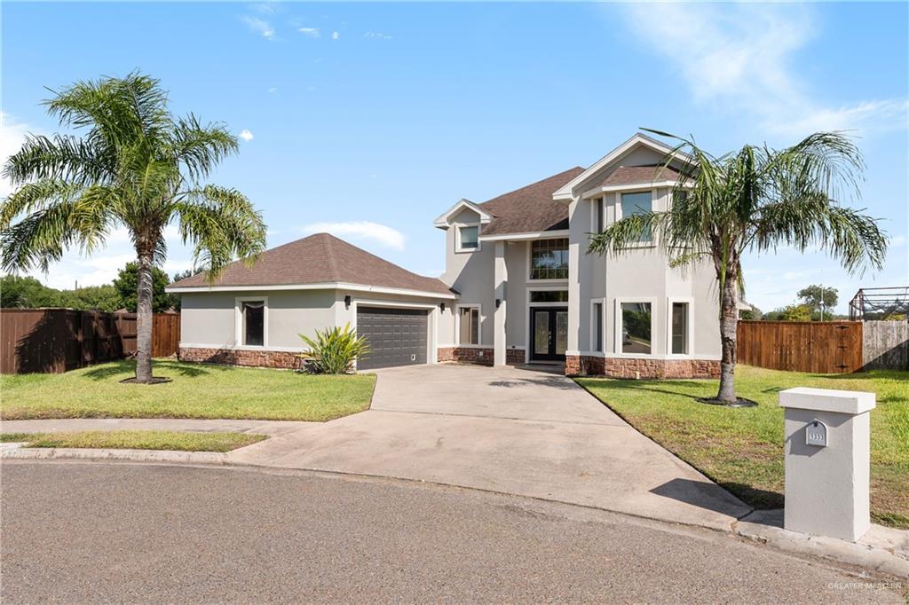 1333 Marble Road Pharr, TX 78577 - Photo 1 of 1 a front view of a house with a garden and trees