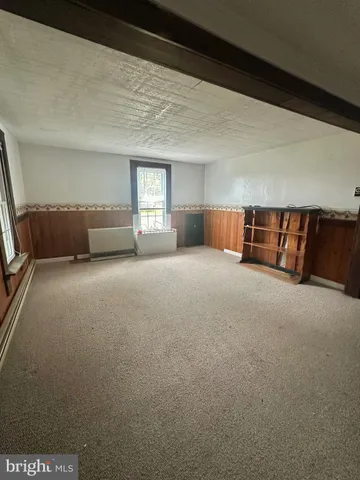 a view of an empty room with windows