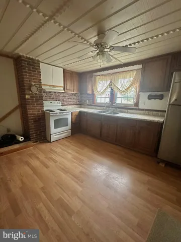 a large kitchen with a stove a sink and dishwasher