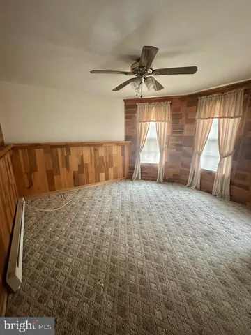 a large bed sitting in a room next to a window
