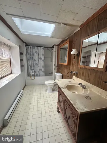 a bathroom with a sink a toilet and mirror