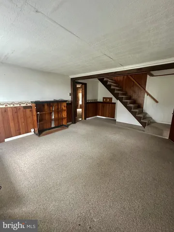a view of an empty room with a fireplace