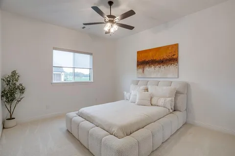a bedroom with a bed and a painting on the wall