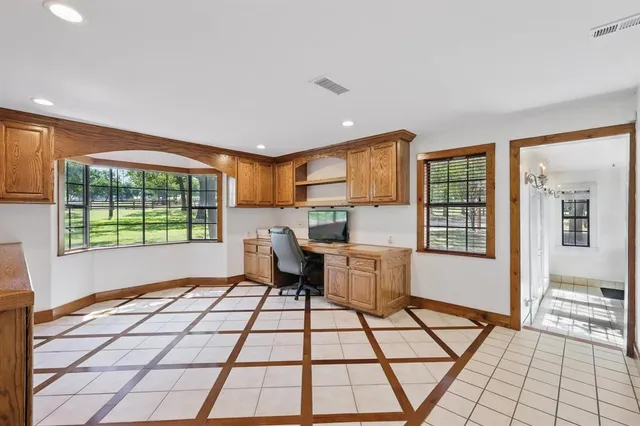 a living room with a large window and furniture