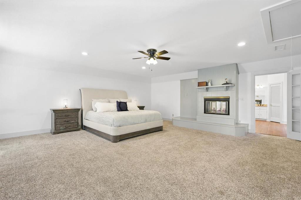 1189 West Jeter Road Bartonville, TX 76226 - Photo 14 of 40 a bedroom with a bed and a chandelier