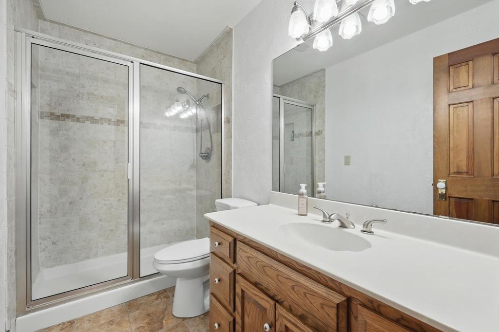 1189 West Jeter Road Bartonville, TX 76226 - Photo 19 of 40 a bathroom with a sink a toilet and shower
