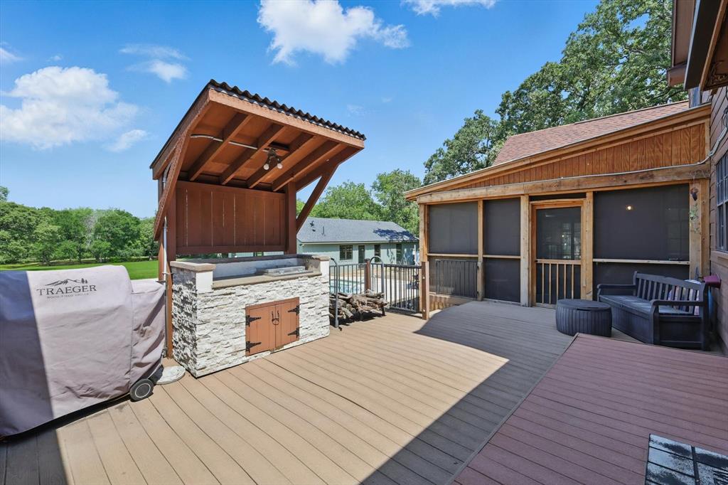 1189 West Jeter Road Bartonville, TX 76226 - Photo 22 of 40 a view of a deck with wooden floor and barbeque oven