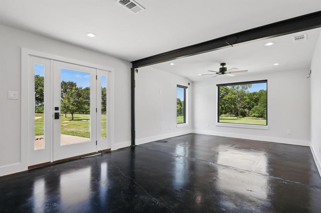 1189 West Jeter Road Bartonville, TX 76226 - Photo 28 of 40 a view of an empty room with wooden floor and a window