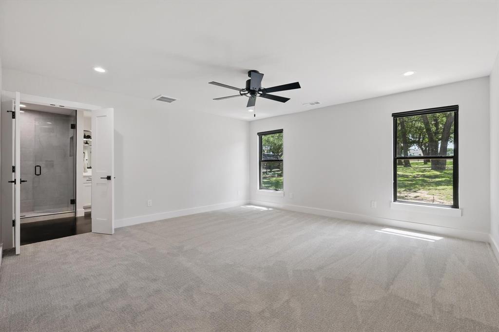 1189 West Jeter Road Bartonville, TX 76226 - Photo 31 of 40 an empty room with windows and a ceiling fan
