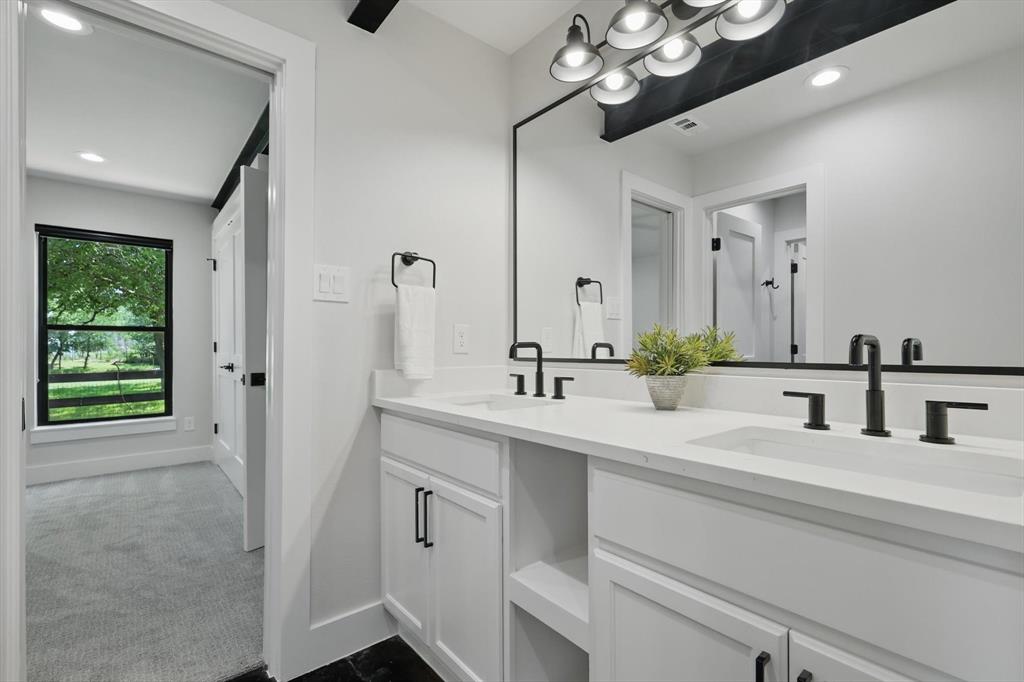 1189 West Jeter Road Bartonville, TX 76226 - Photo 35 of 40 a bathroom with a double vanity sink a mirror and a shower