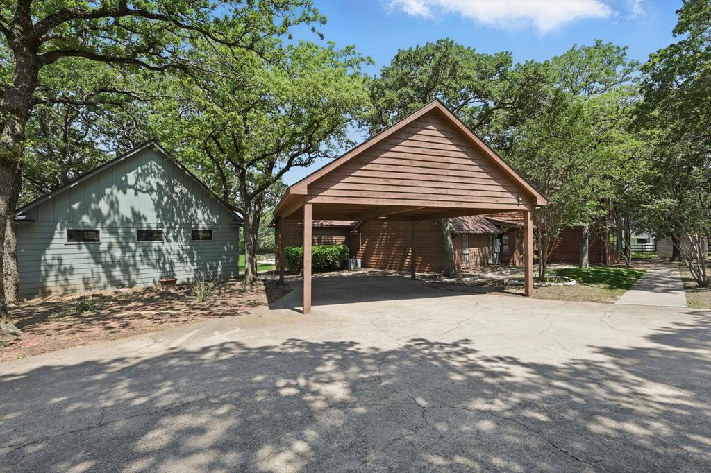 1189 West Jeter Road Bartonville, TX 76226 - Photo 37 of 40 a front view of a house with a yard and potted plants