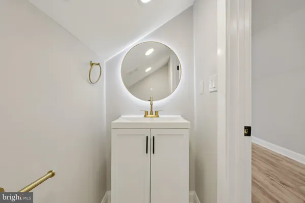 a bathroom with a sink a mirror and vanity