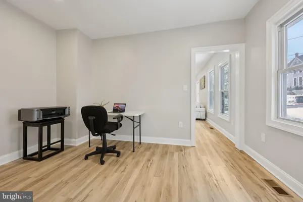 a view of a workspace with wooden floor
