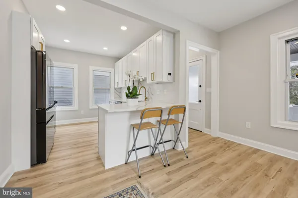 a kitchen with granite countertop white cabinets and stainless steel appliances