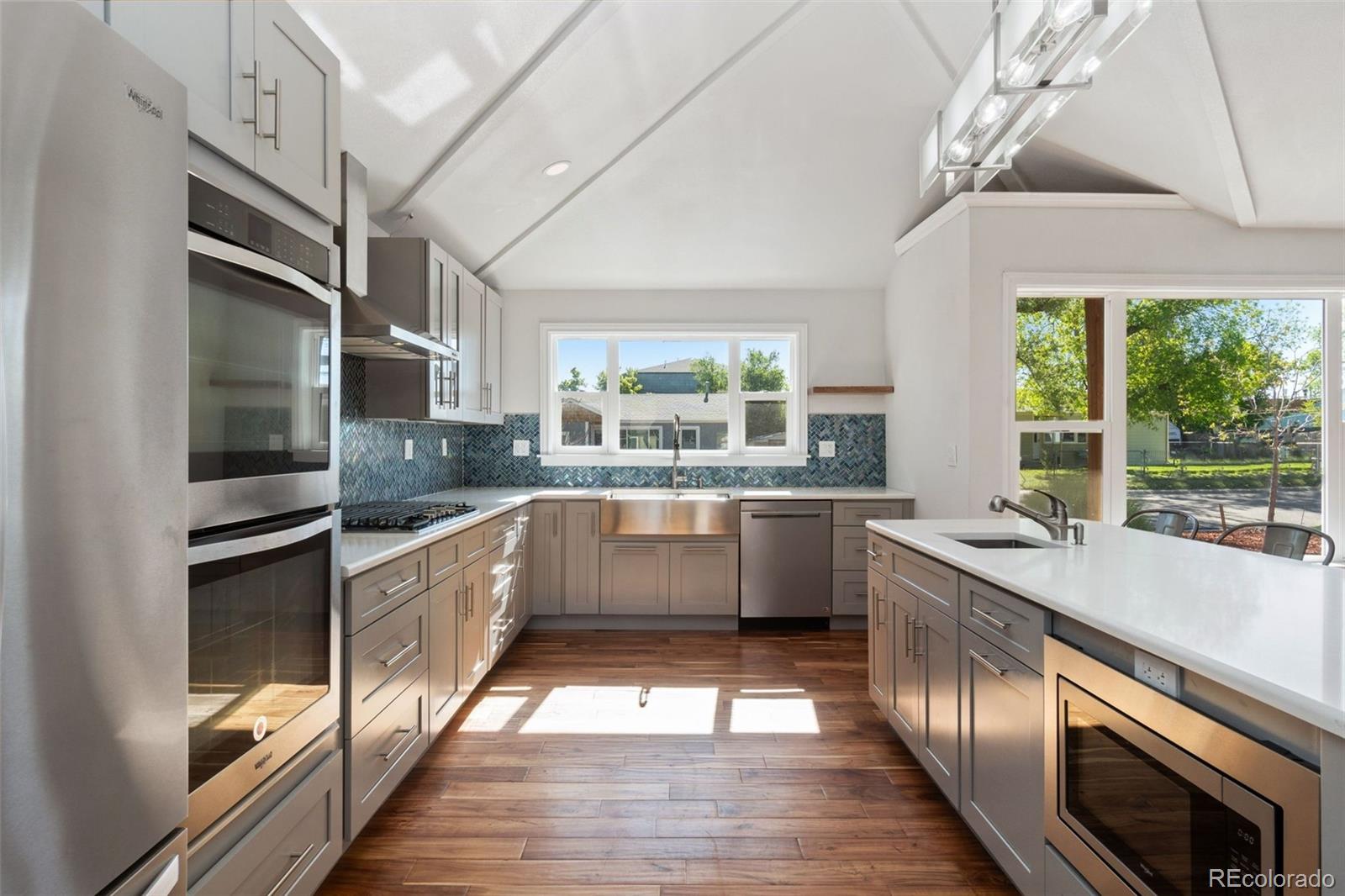 4545 Ingalls Street Wheat Ridge, CO 80033 - Photo 13 of 30 a large kitchen with stainless steel appliances granite countertop a sink and cabinets