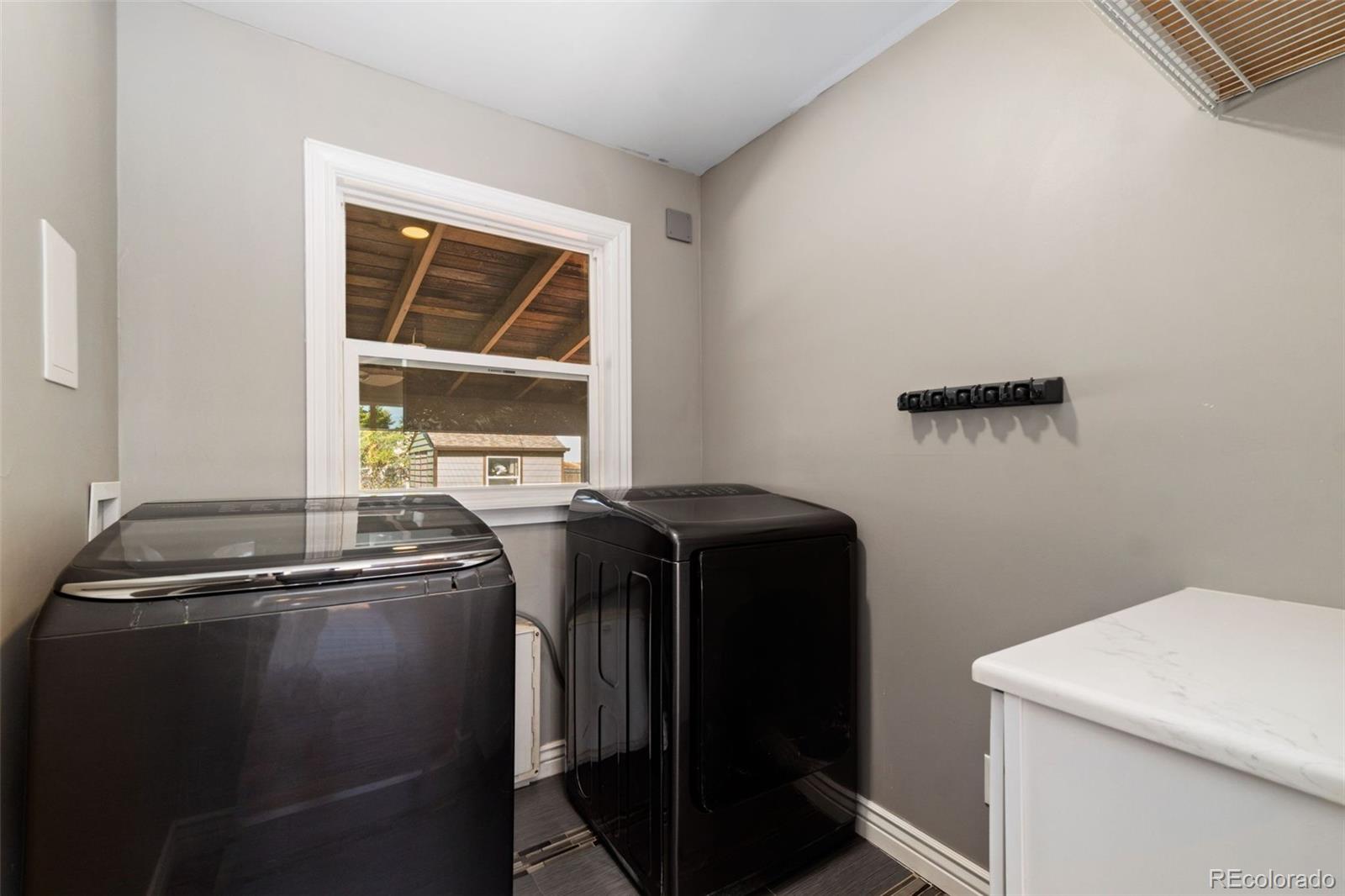 4545 Ingalls Street Wheat Ridge, CO 80033 - Photo 19 of 30 a view of storage and utility room with washer and dryer