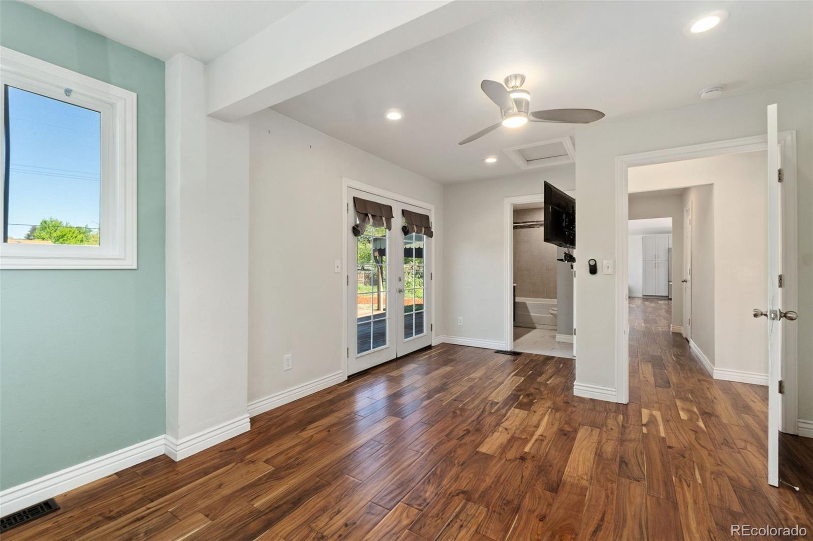 4545 Ingalls Street Wheat Ridge, CO 80033 - Photo 20 of 30 a view of an empty room with wooden floor and a window