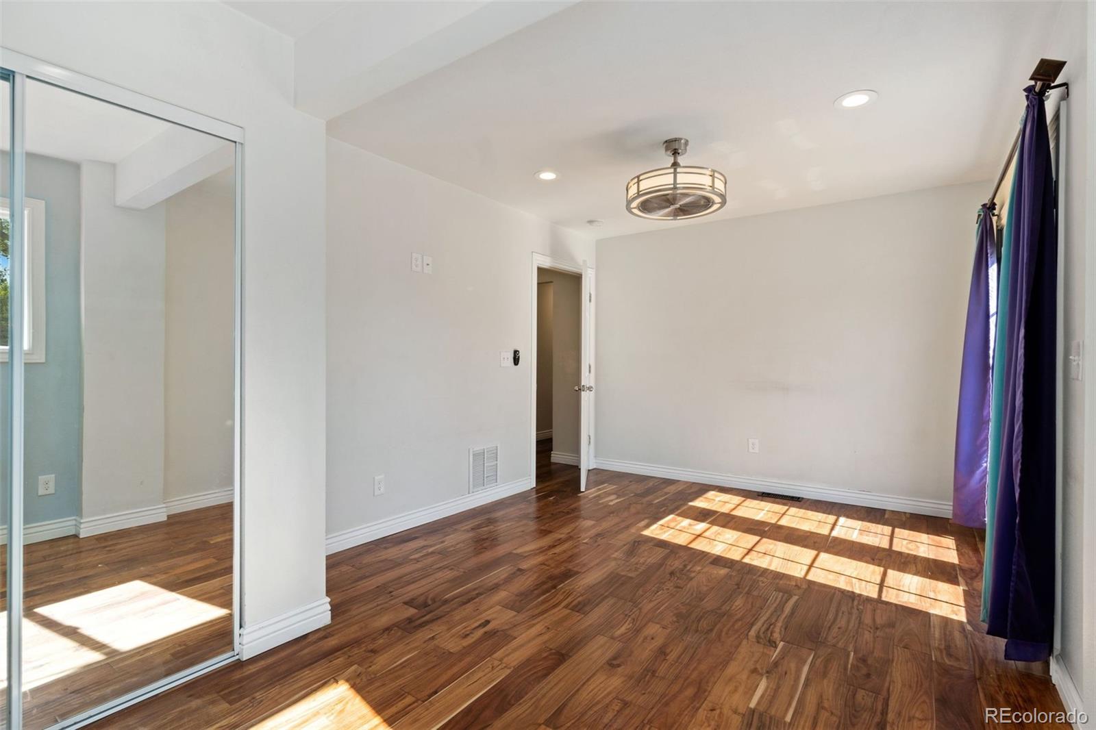 4545 Ingalls Street Wheat Ridge, CO 80033 - Photo 23 of 30 a view of an empty room with wooden floor and a window