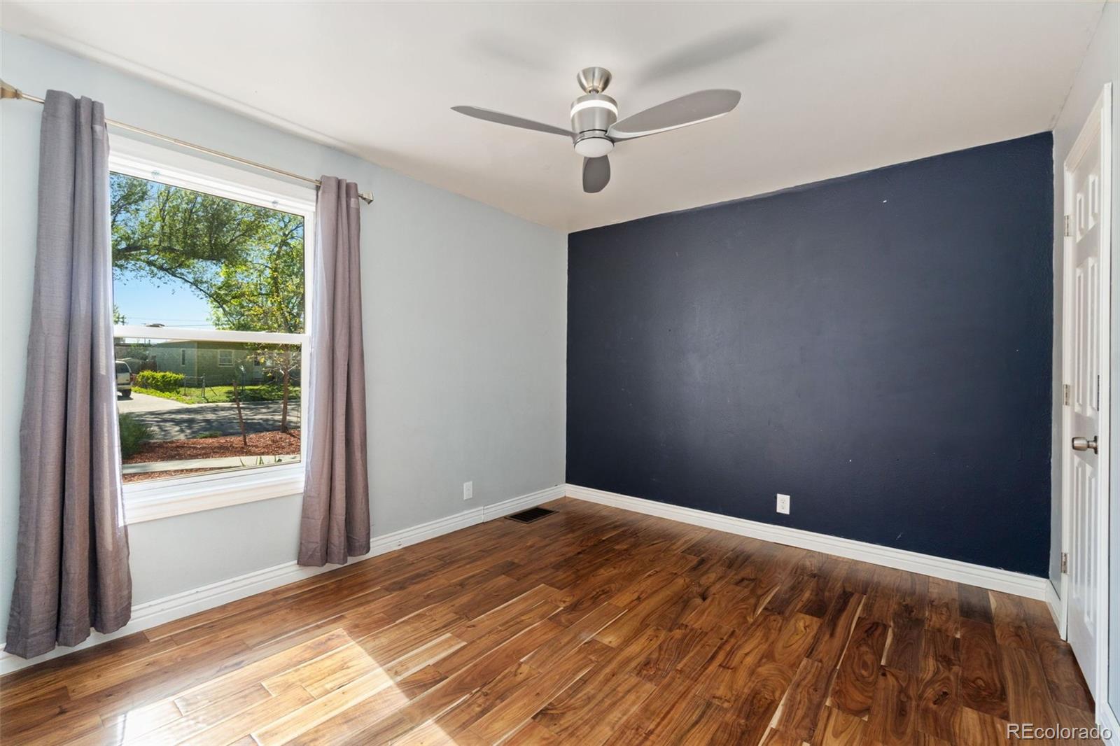 4545 Ingalls Street Wheat Ridge, CO 80033 - Photo 24 of 30 wooden floor in an empty room with a window