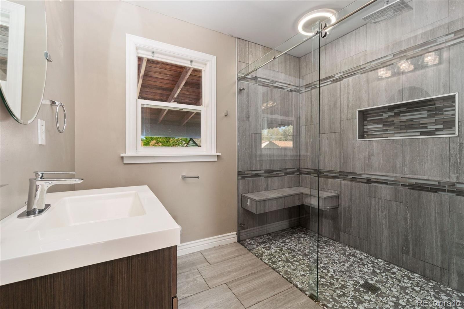 4545 Ingalls Street Wheat Ridge, CO 80033 - Photo 25 of 30 a bathroom with a sink a toilet and shower