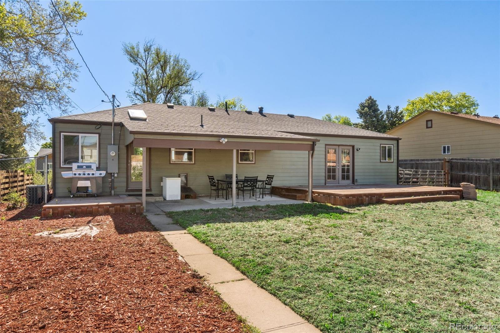 4545 Ingalls Street Wheat Ridge, CO 80033 - Photo 27 of 30 a view of a house with a garden and yard