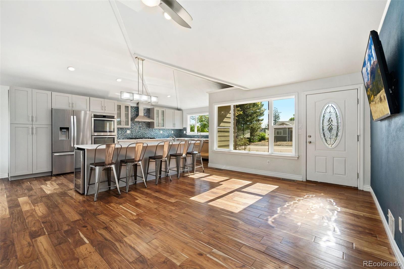 4545 Ingalls Street Wheat Ridge, CO 80033 - Photo 8 of 30 a living room with stainless steel appliances furniture and a kitchen view